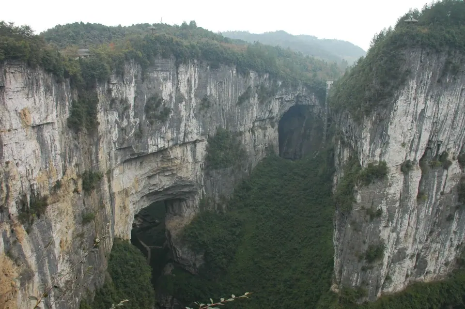 Limestone cliffs and a natural stone arch in Wulong’s Three Natural Bridges area